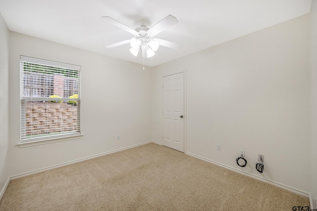 empty room with baseboards, a ceiling fan, and carpet flooring