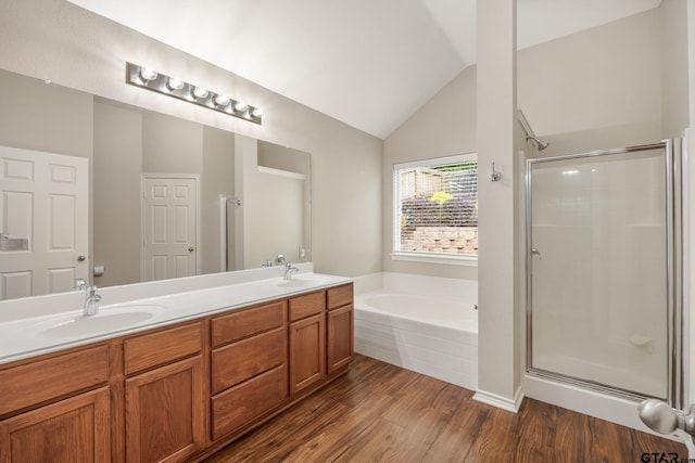 full bath with a sink, a bath, and a shower stall