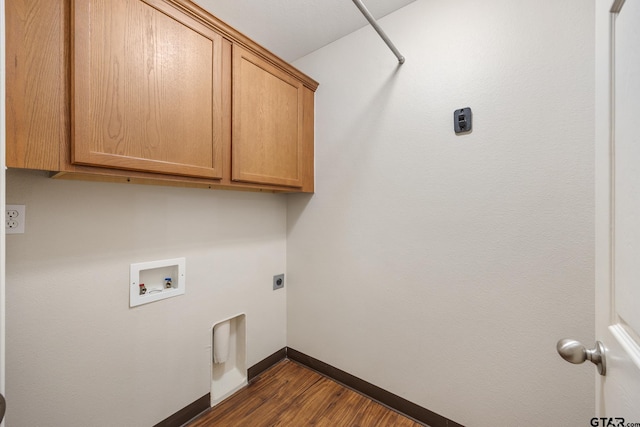 washroom with washer hookup, electric dryer hookup, dark wood finished floors, cabinet space, and baseboards
