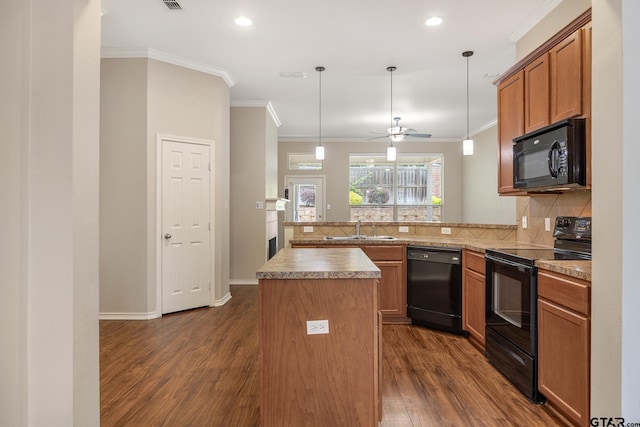 kitchen with ornamental molding, dark wood-style flooring, a sink, backsplash, and black appliances