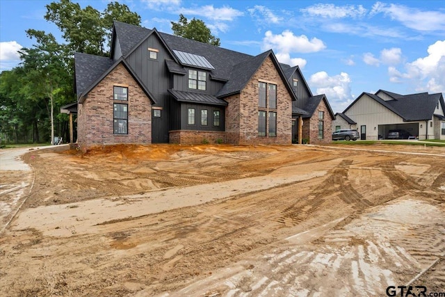 300 White-N-Gail Ln, Bullard, TX 75757 - modern farmhouse style home featuring a standing seam roof, board and batten siding, metal roof, brick siding, and a shingled roof