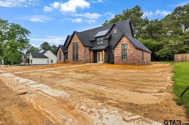 300 White-N-Gail Ln, Bullard, TX 75757 - modern farmhouse style home with a standing seam roof, french doors, board and batten siding, and metal roof