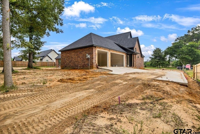 300 White-N-Gail Ln, Bullard, TX 75757 - view of side of property with brick siding, a garage, concrete driveway, and roof with shingles