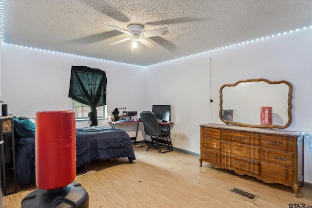 13386 Fm 858, Ben Wheeler, TX 75754 - bedroom featuring wood finished floors, a textured ceiling, and a desk