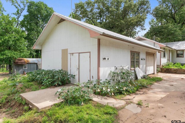 13386 Fm 858, Ben Wheeler, TX 75754 - view of outbuilding with concrete driveway, an attached garage, and an outbuilding