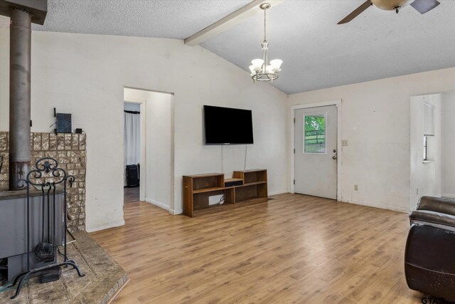 13386 Fm 858, Ben Wheeler, TX 75754 - living area featuring a wood stove, a ceiling fan, light wood-type flooring, a textured ceiling, and baseboards