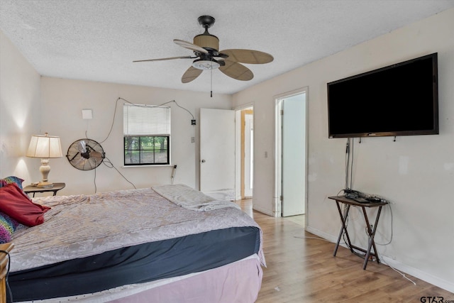 13386 Fm 858, Ben Wheeler, TX 75754 - bedroom with wood finished floors, a textured ceiling, baseboards, and a ceiling fan