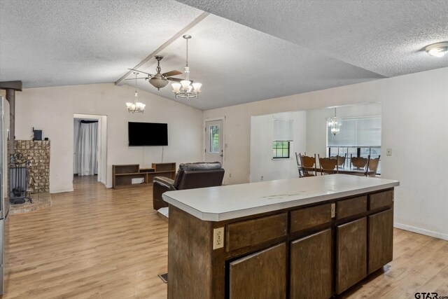 13386 Fm 858, Ben Wheeler, TX 75754 - kitchen featuring a chandelier, light wood-style flooring, a textured ceiling, vaulted ceiling, and light countertops