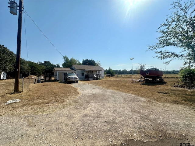 view of front facade with a rural view