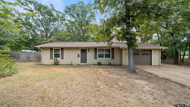 ranch-style house with a garage and a front yard