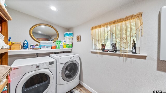 washroom featuring hardwood / wood-style flooring and washer and clothes dryer