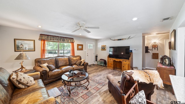 living room featuring light hardwood / wood-style flooring and ceiling fan