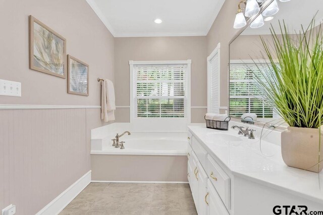 bathroom with wainscoting, vanity, ornamental molding, and a garden tub