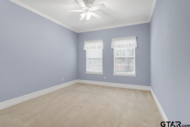 spare room featuring baseboards, a ceiling fan, crown molding, and light colored carpet