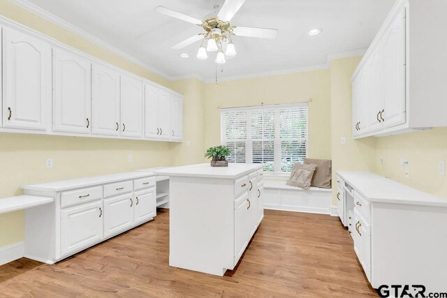 kitchen with white cabinets, ceiling fan, and a kitchen island