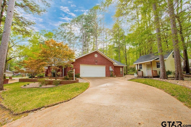 ranch-style home featuring driveway, brick siding, a garage, and a front lawn