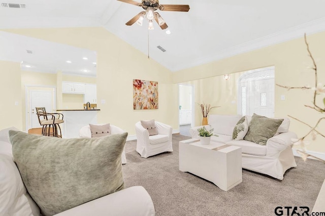 living area featuring lofted ceiling, ceiling fan, visible vents, and light carpet