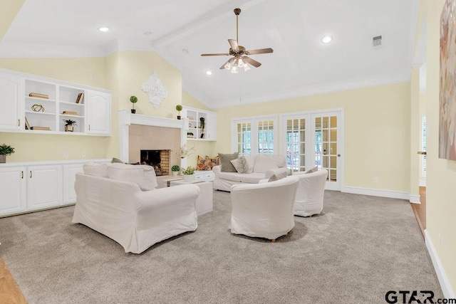 carpeted living area with high vaulted ceiling, baseboards, visible vents, a ceiling fan, and a fireplace