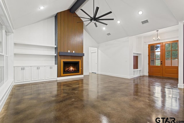 unfurnished living room with a large fireplace, french doors, beamed ceiling, high vaulted ceiling, and ceiling fan with notable chandelier