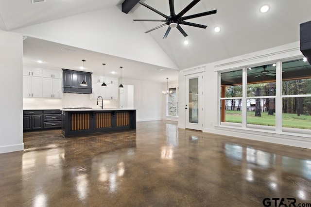 kitchen featuring a kitchen breakfast bar, tasteful backsplash, sink, beamed ceiling, and a large island