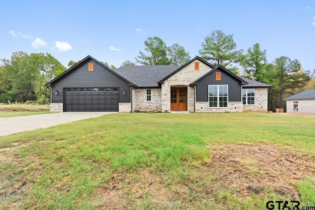 view of front of property featuring a front lawn and a garage