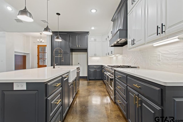 kitchen with tasteful backsplash, an island with sink, pendant lighting, double oven range, and custom exhaust hood