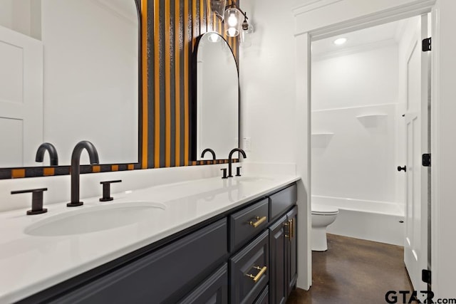 bathroom featuring vanity, toilet, and ornamental molding