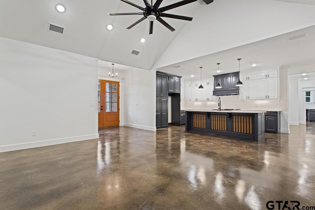 living room featuring ceiling fan with notable chandelier, high vaulted ceiling, and a healthy amount of sunlight