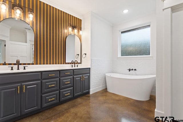 bathroom featuring vanity, ornamental molding, concrete floors, and a tub