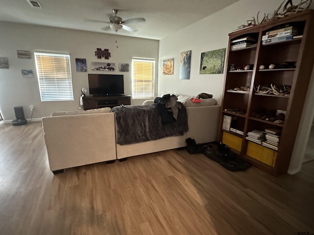 living room with ceiling fan and hardwood / wood-style flooring