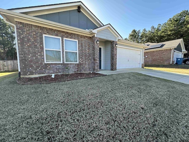 view of front of home with solar panels, a garage, and a front lawn