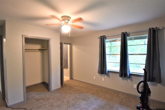 unfurnished bedroom with light carpet, ceiling fan, and a closet