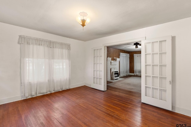 unfurnished room featuring ceiling fan, french doors, and dark hardwood / wood-style floors