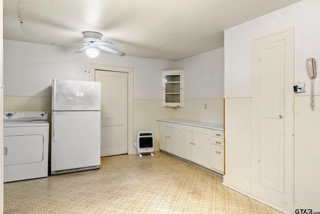 kitchen featuring white cabinetry, ceiling fan, washer / clothes dryer, heating unit, and white fridge