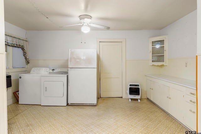 laundry area featuring washer and clothes dryer, ceiling fan, cabinets, and heating unit