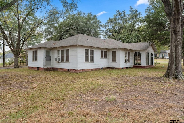 rear view of house with a yard