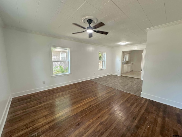 1409 W 3rd St, Tyler, TX 75701 - spare room featuring ornamental molding, dark wood-type flooring, and ceiling fan