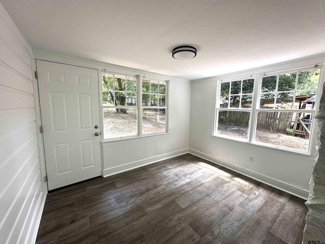 1409 W 3rd St, Tyler, TX 75701 - entrance foyer with dark wood finished floors, a textured ceiling, and ornamental molding