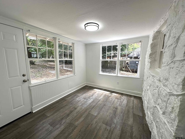 1409 W 3rd St, Tyler, TX 75701 - unfurnished room featuring wood finished floors, healthy amount of natural light, and a textured ceiling