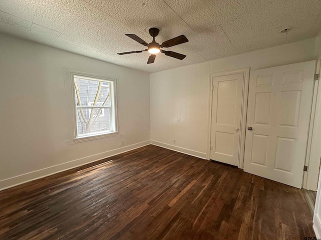 1409 W 3rd St, Tyler, TX 75701 - unfurnished bedroom featuring dark wood-style floors, a textured ceiling, and a ceiling fan