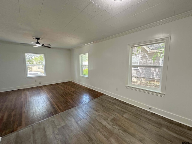 1409 W 3rd St, Tyler, TX 75701 - empty room featuring crown molding, dark wood-style flooring, plenty of natural light, and ceiling fan