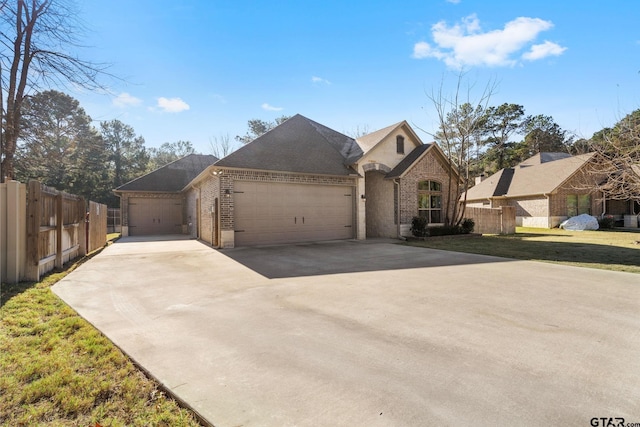 view of front of property with a garage and a front lawn