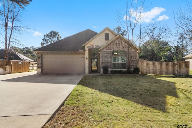 view of front of home with a garage and a front yard