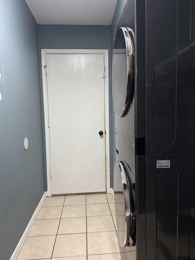 10845 Nashville Dr, Flint, TX 75762 - washroom with stacked washer and clothes dryer, laundry area, light tile patterned floors, and baseboards