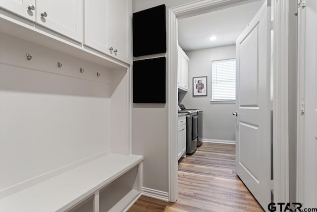 mudroom featuring washing machine and dryer and light wood-type flooring