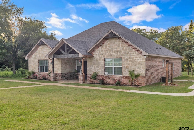 10708 C R 494, Tyler, TX 75706 - view of front of home with stone siding, a front lawn, and a shingled roof