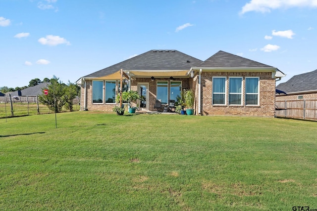 back of property featuring a lawn and a patio area