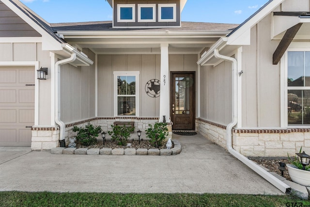 doorway to property with a garage and a porch