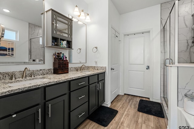 bathroom featuring an enclosed shower and vanity