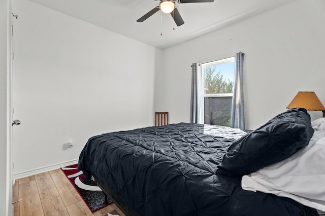 bedroom featuring hardwood / wood-style flooring and ceiling fan